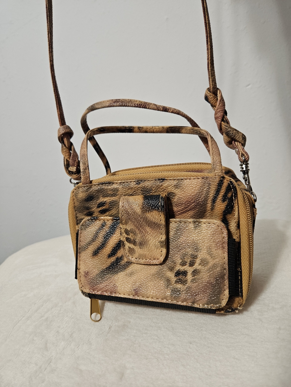 Leopard print mini crossbody bag with adjustable strap.
